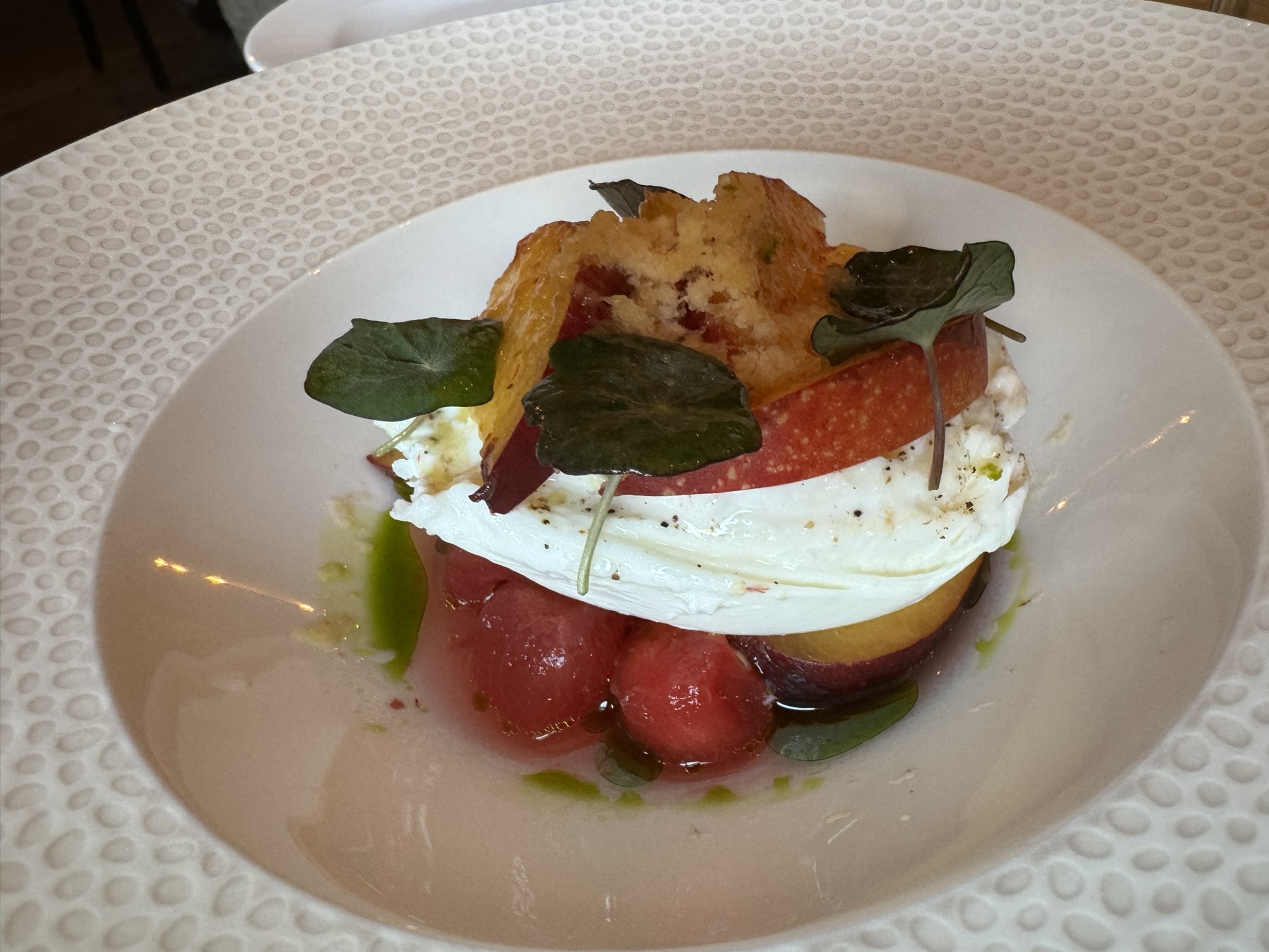 TO START: Burrata with watermelon, nectarine, nasturtium and Madagascan pepper. Image: Iain Smith